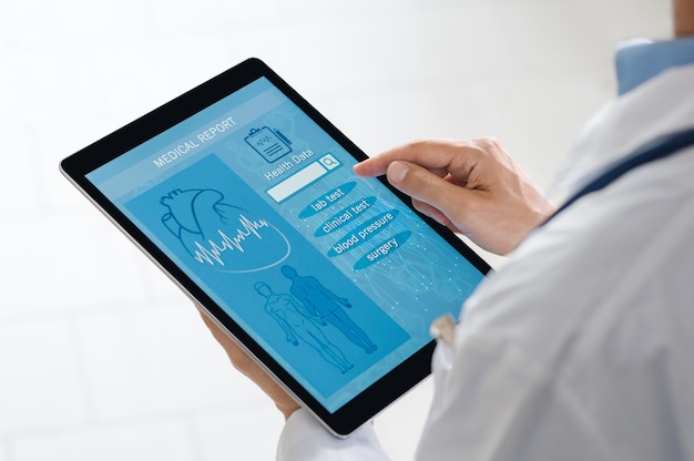 A doctor using a tablet to view a machine learning-powered diagnostic dashboard, displaying patient data overlaid with predictive insights and treatment recommendations. Focus on the interaction between human expertise and AI assistance.