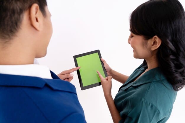 A doctor using a tablet to consult with an AI assistant that is displaying patient data and treatment options. The doctor is smiling and engaged, showing trust and confidence in the AI's capabilities. This highlights the potential for AI to enhance, not replace, human expertise in healthcare.